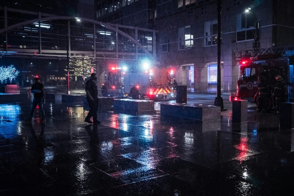 man in black jacket walking on street during night time